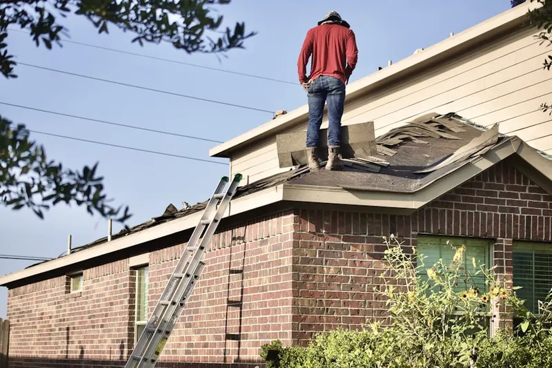 Professional roofer working on a residential roof in Medley Manor